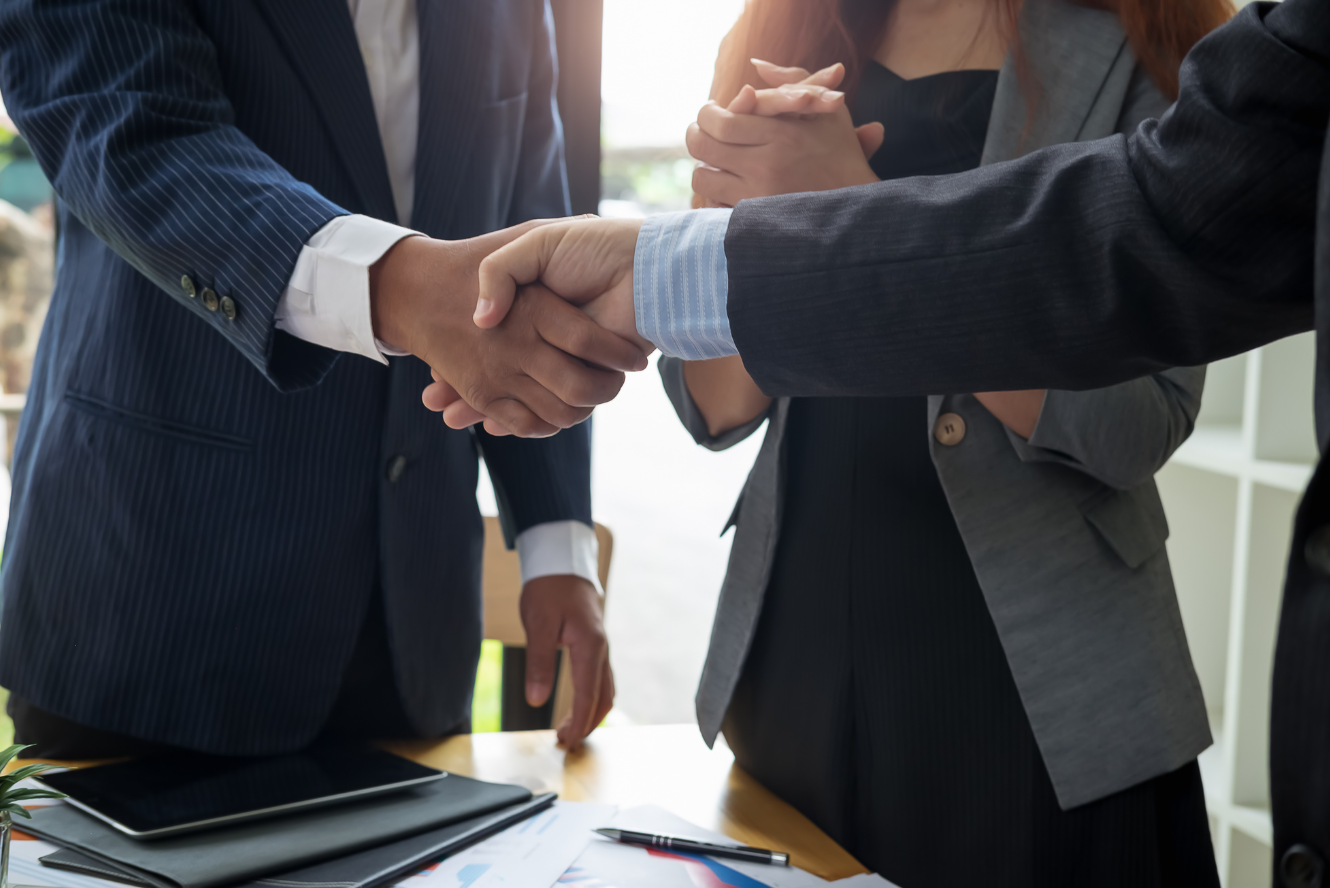A photo of businesspeople shaking hands. 