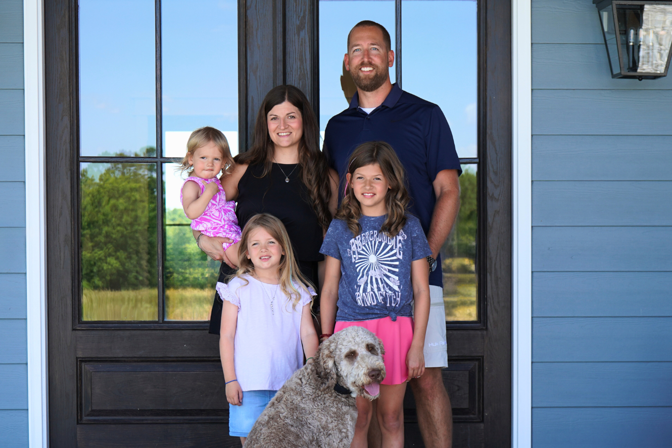 A family in front of their home.